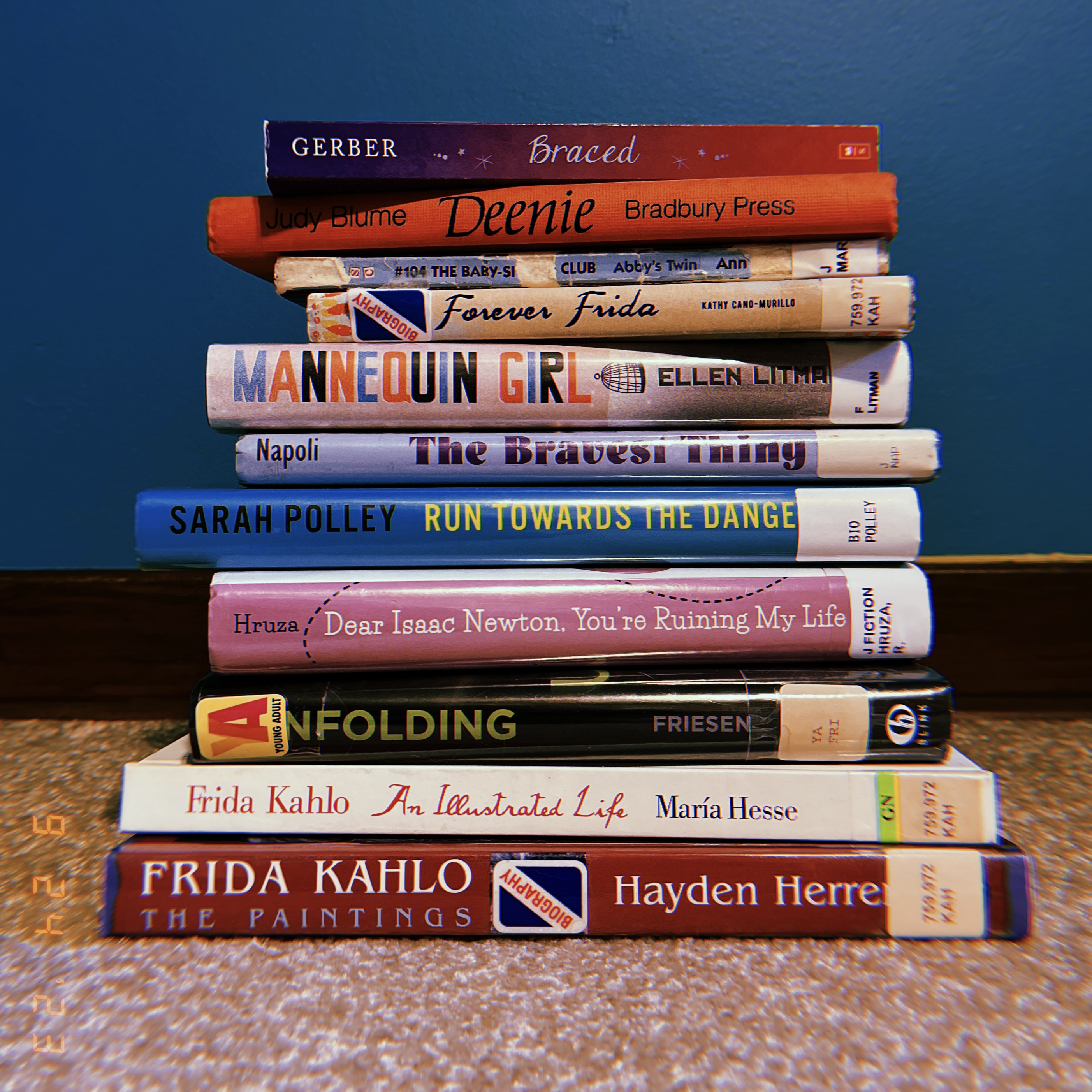 A stack of eleven books about scoliosis.